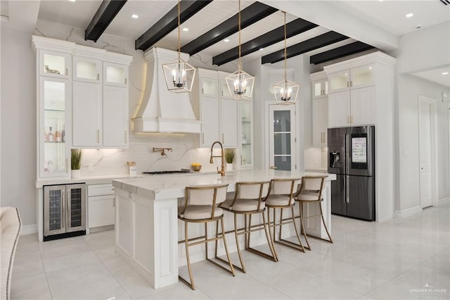 3505 Vendome Dr, Mcallen, TX 78504 - kitchen with black fridge, beverage cooler, backsplash, beamed ceiling, and a large island