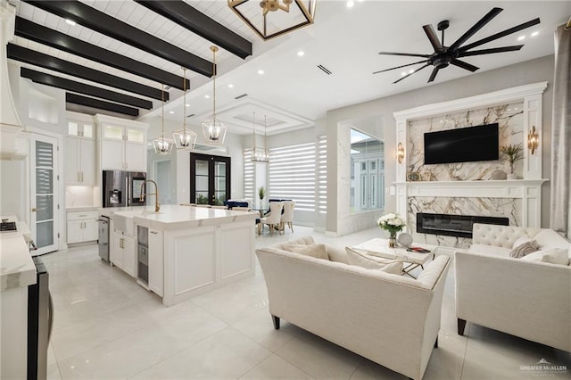 3505 Vendome Dr, Mcallen, TX 78504 - living area with a high end fireplace, recessed lighting, french doors, ceiling fan, and wooden ceiling with exposed beams