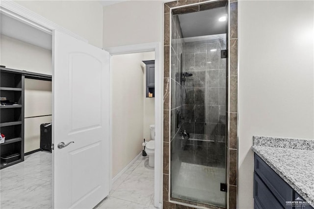 bathroom featuring marble finish floor, a stall shower, toilet, and baseboards