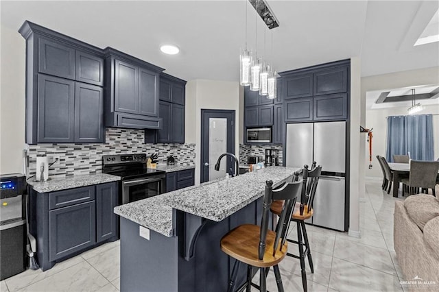 kitchen featuring a kitchen breakfast bar, decorative light fixtures, light stone countertops, stainless steel appliances, and backsplash