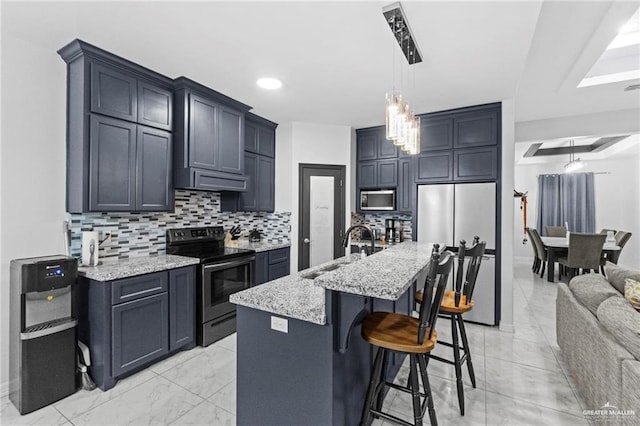 kitchen with marble finish floor, tasteful backsplash, appliances with stainless steel finishes, a sink, and light stone countertops