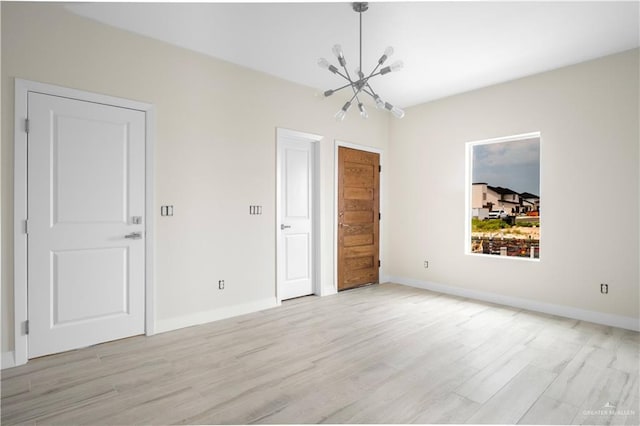 2609 E Solar Dr, Mission, TX 78574 - empty room with light wood finished floors, a chandelier, and baseboards