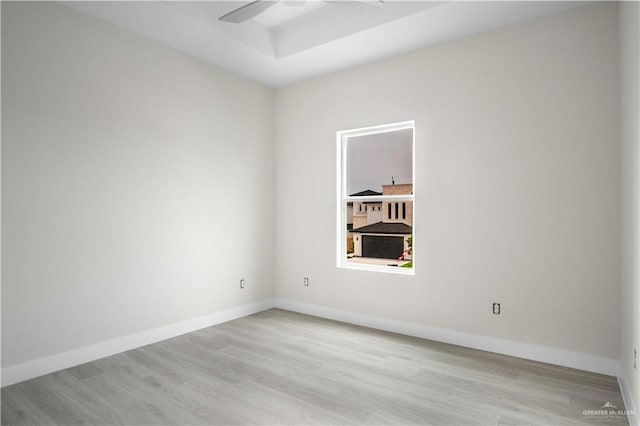 2609 E Solar Dr, Mission, TX 78574 - spare room featuring light wood-style flooring, ceiling fan, baseboards, and a raised ceiling