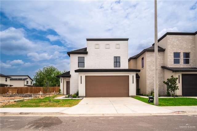 2609 E Solar Dr, Mission, TX 78574 - contemporary home with an attached garage, brick siding, and concrete driveway
