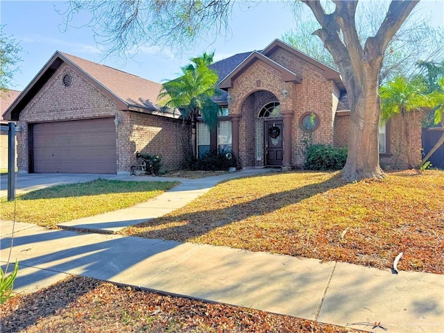 view of front of property featuring a front yard and a garage