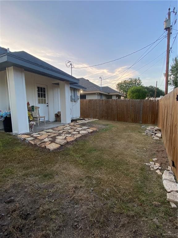 814 N Flag St N, Pharr, TX 78577 - yard at dusk with a fenced backyard and a patio area