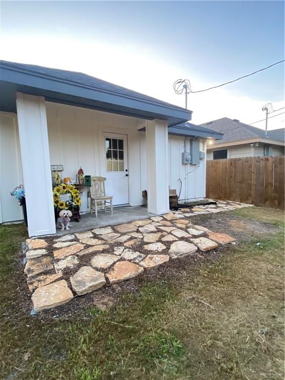 814 N Flag St N, Pharr, TX 78577 - rear view of property with board and batten siding and a patio