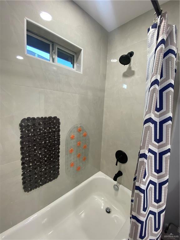 814 N Flag St N, Pharr, TX 78577 - bathroom featuring shower / bath combination with curtain
