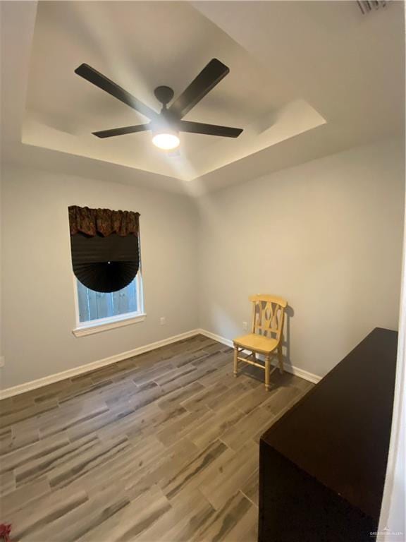 814 N Flag St N, Pharr, TX 78577 - unfurnished room featuring a tray ceiling, ceiling fan, and wood finished floors