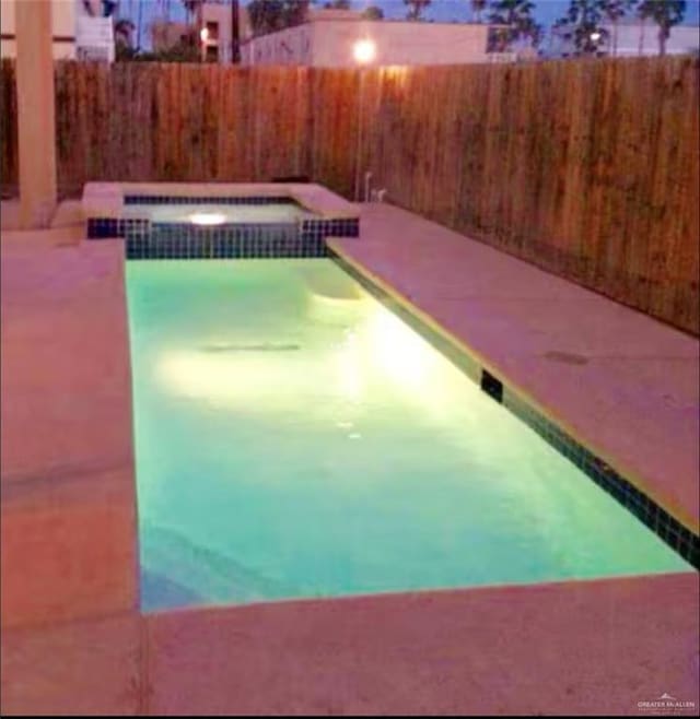 view of pool with an in ground hot tub