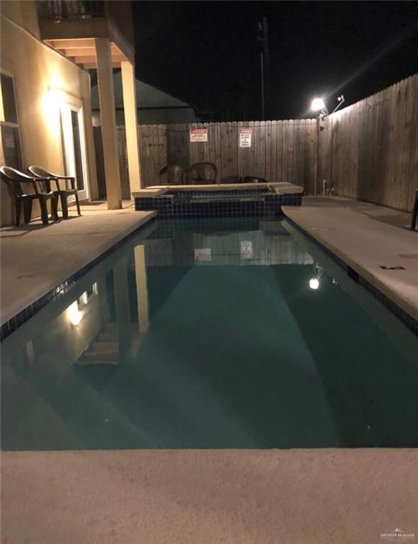 107 E Pike St, South Padre Island, TX 78597 - pool at twilight with a jacuzzi and a patio