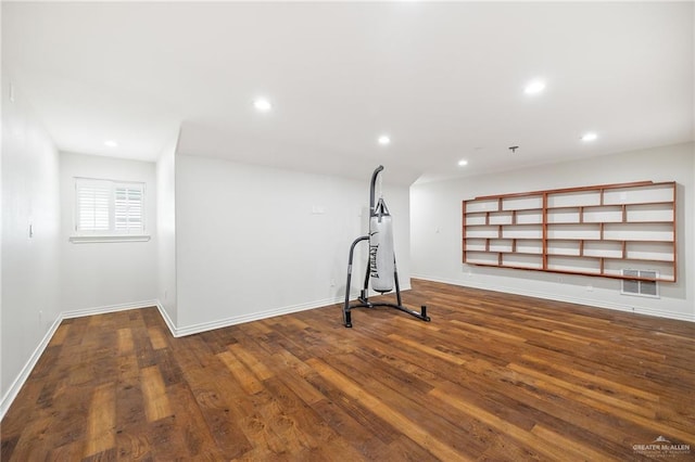 exercise room featuring dark hardwood / wood-style floors