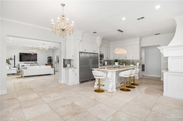 kitchen featuring tasteful backsplash, a breakfast bar, white cabinets, and appliances with stainless steel finishes