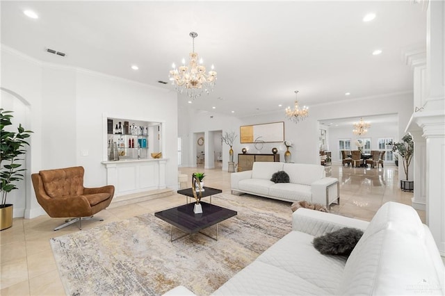 tiled living room featuring a notable chandelier, ornamental molding, and ornate columns