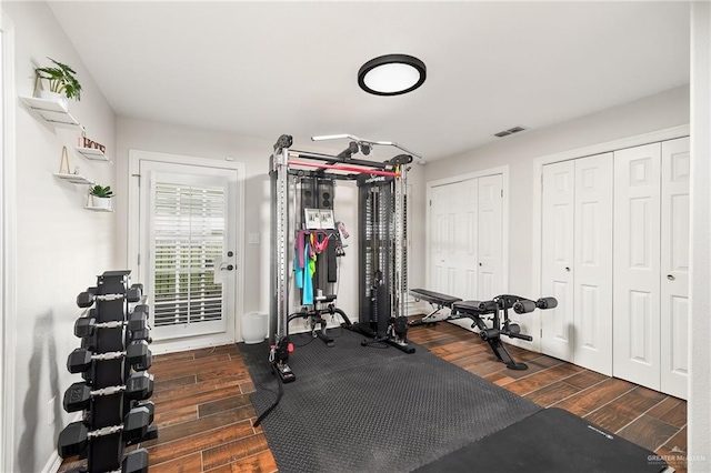 workout room with dark wood-type flooring