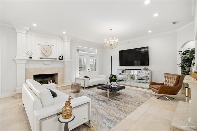 living room with light tile patterned floors, crown molding, a high end fireplace, and an inviting chandelier