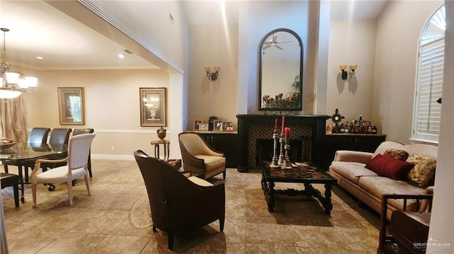 living area with a notable chandelier and ornamental molding