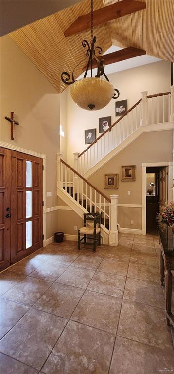 entrance foyer with high vaulted ceiling and wooden ceiling