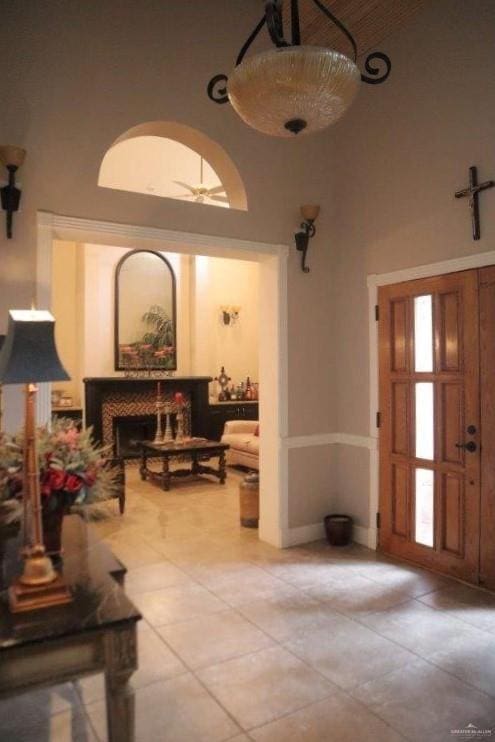 foyer entrance featuring a high ceiling and light tile patterned floors