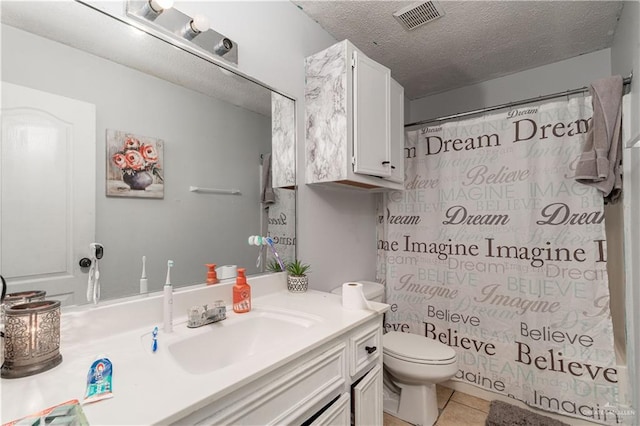 905 N 6th Ave, Edinburg, TX 78541 - bathroom with vanity, toilet, a textured ceiling, tile patterned flooring, and curtained shower