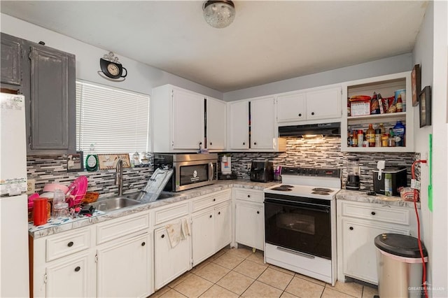 905 N 6th Ave, Edinburg, TX 78541 - kitchen with range with electric cooktop, under cabinet range hood, freestanding refrigerator, and tasteful backsplash