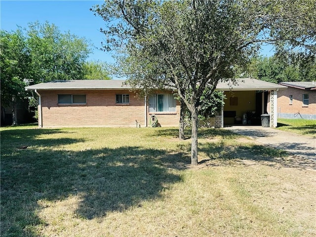 view of front of property with a front yard and a carport