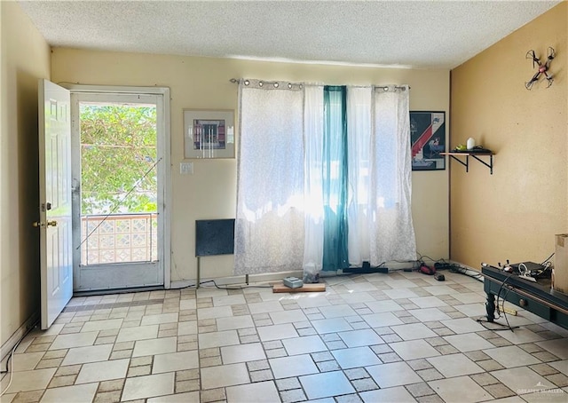 entryway with a textured ceiling