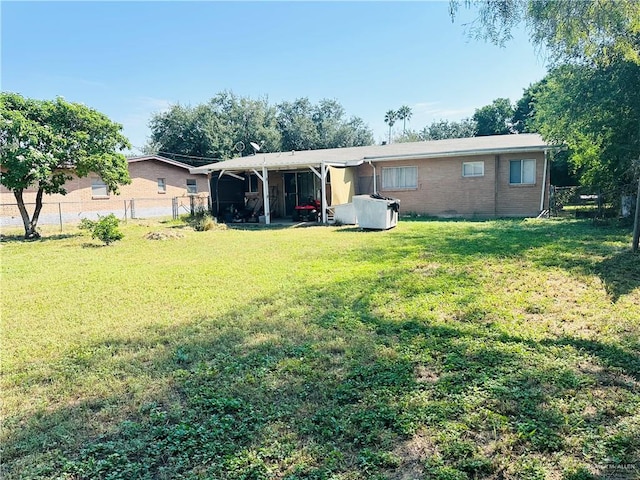 back of property featuring a yard