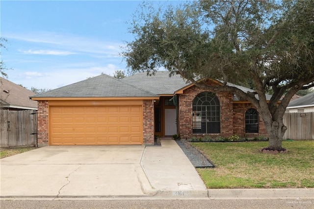 single story home featuring a garage and a front lawn