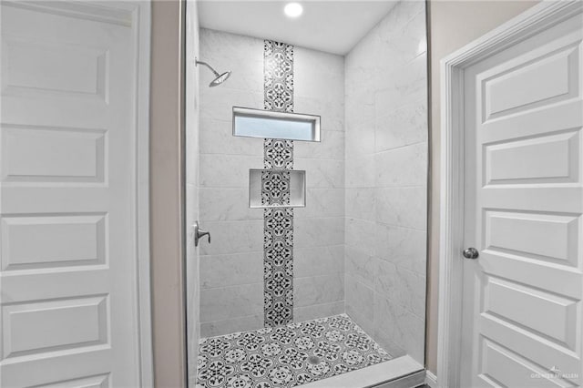 bathroom with a tile shower