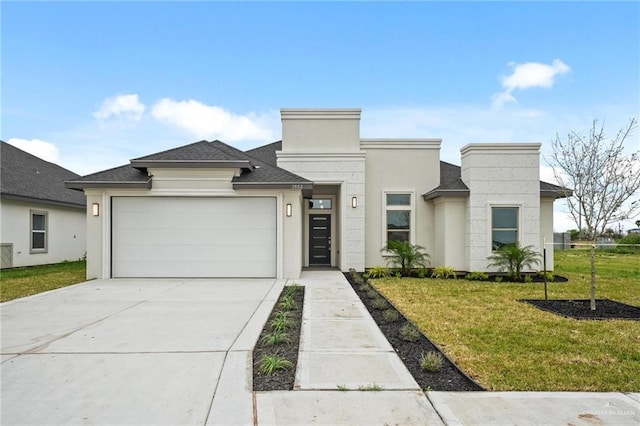 view of front of property with a front yard and a garage