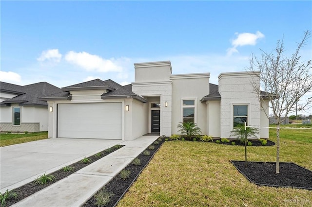 view of front of property with a front yard and a garage