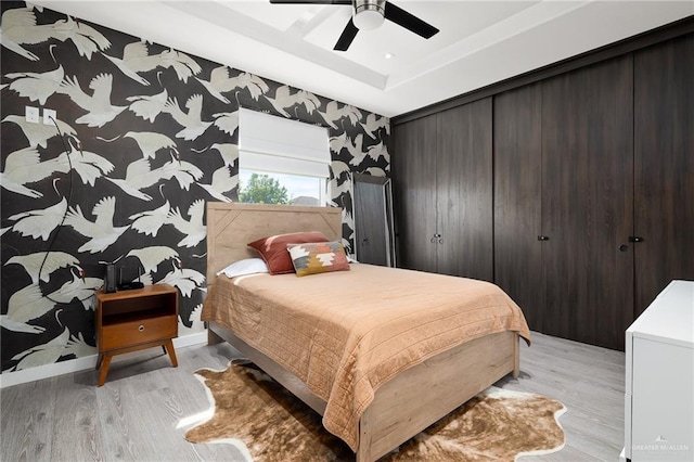 bedroom with ceiling fan and light hardwood / wood-style floors