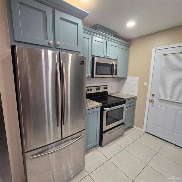 9218 N 29th Ln, Mcallen, TX 78504 - kitchen featuring stainless steel appliances, light stone counters, light tile patterned floors, and tasteful backsplash