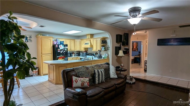 living room with ceiling fan, light tile patterned floors, and sink