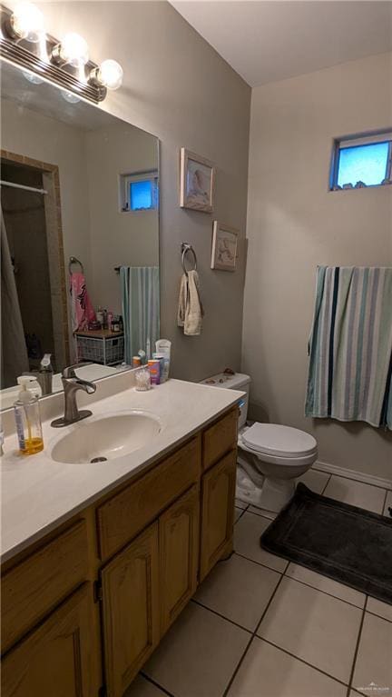 bathroom with tile patterned floors, vanity, and toilet