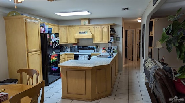 kitchen with tasteful backsplash, tile countertops, white range with electric cooktop, black refrigerator, and custom exhaust hood