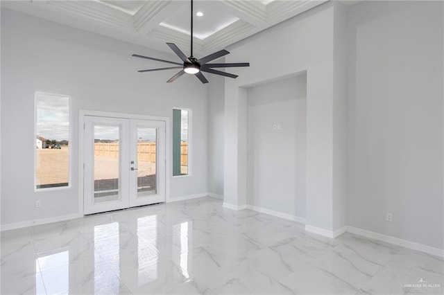 unfurnished room featuring beamed ceiling, a high ceiling, coffered ceiling, ceiling fan, and french doors