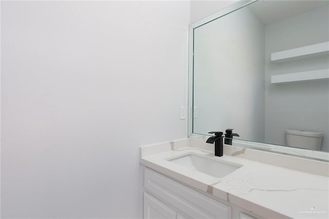 bathroom with vanity and toilet