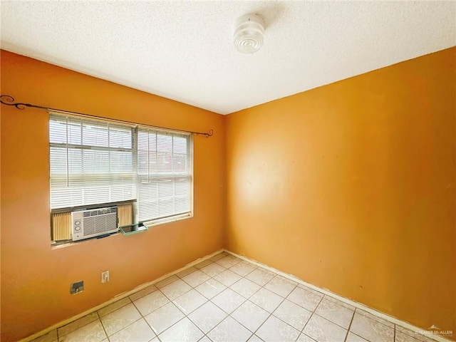 420 Vfw Ave, Elsa, TX 78543 - empty room featuring a textured ceiling, light tile patterned floors, and cooling unit