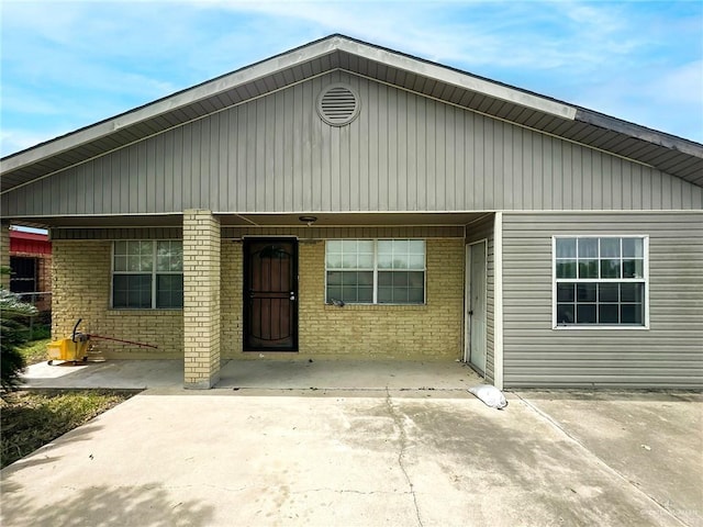 420 Vfw Ave, Elsa, TX 78543 - back of house with brick siding and a carport