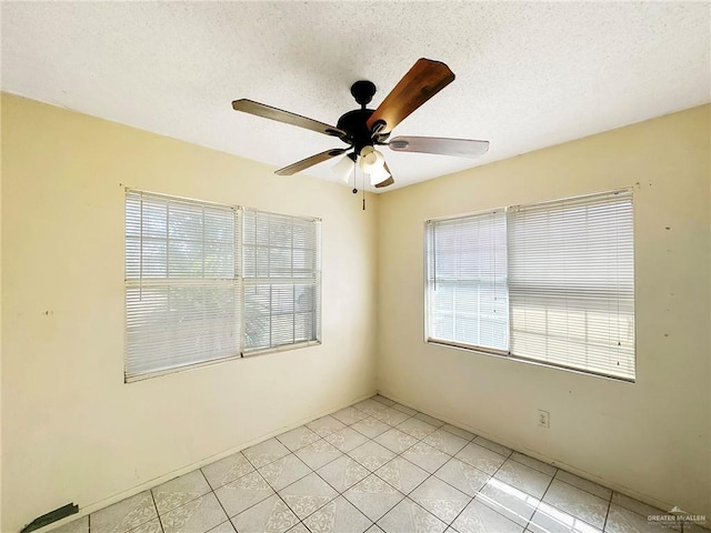 420 Vfw Ave, Elsa, TX 78543 - spare room with ceiling fan, light tile patterned floors, and a textured ceiling
