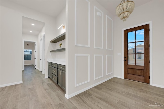 entryway with recessed lighting, baseboards, and light wood finished floors