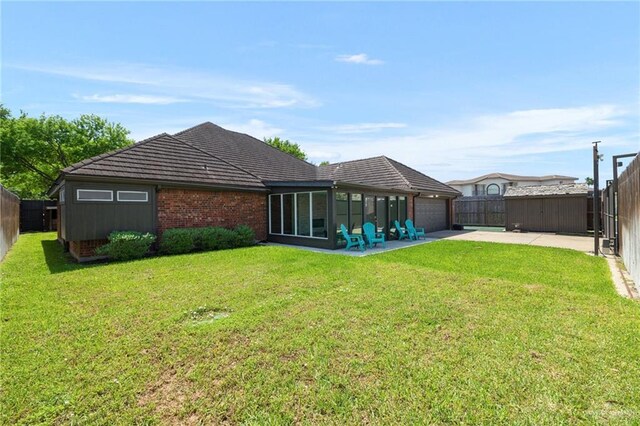 720 Cardinal Ave, Mcallen, TX 78504 - back of house featuring a fenced backyard, a yard, an attached garage, driveway, and a sunroom