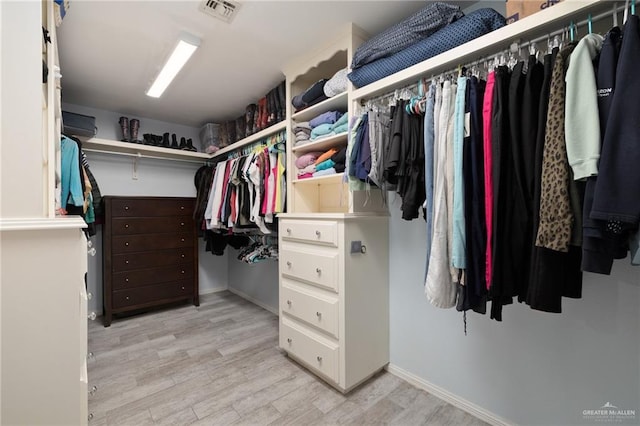 spacious closet featuring light wood-type flooring and visible vents