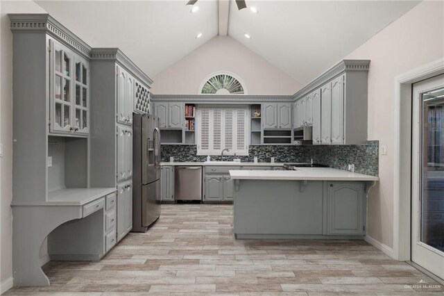 720 Cardinal Ave, Mcallen, TX 78504 - kitchen with stainless steel appliances, open shelves, vaulted ceiling, gray cabinetry, and a peninsula