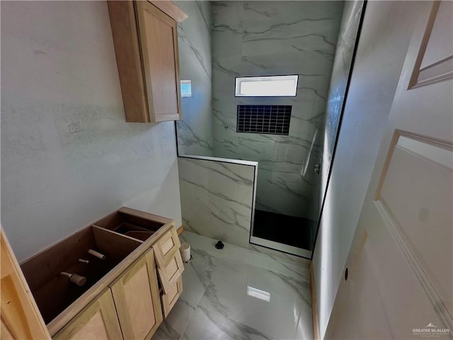 bathroom featuring marble finish floor and a marble finish shower