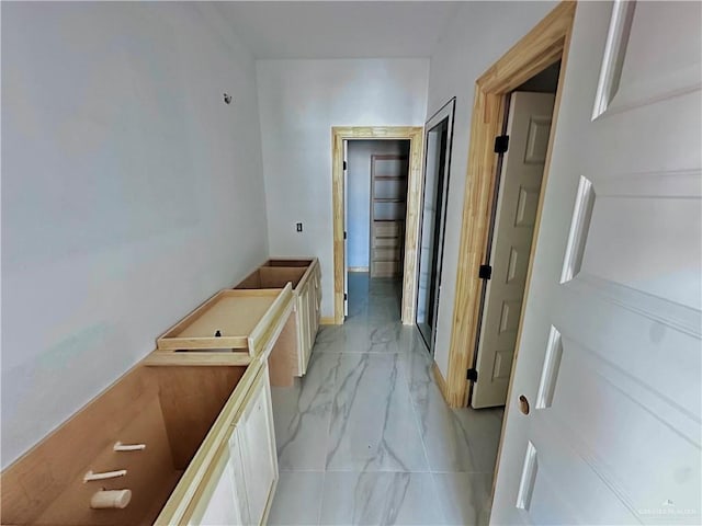 hallway with marble finish floor