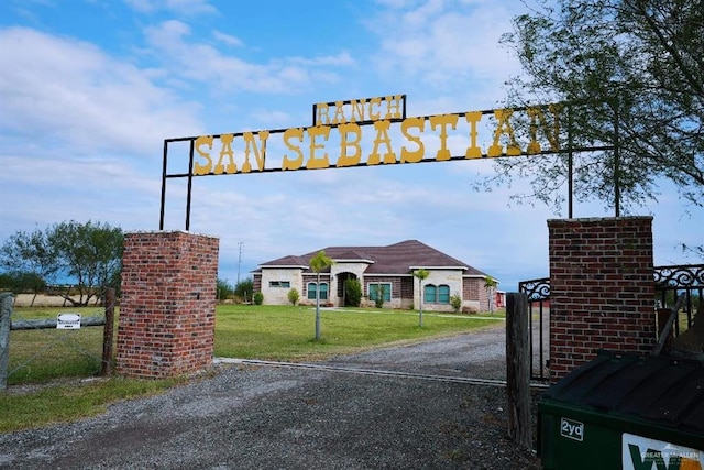 20985 Espinoza Rd, San Benito, TX 78586 - view of dirt / gravel driveway with a gated entry