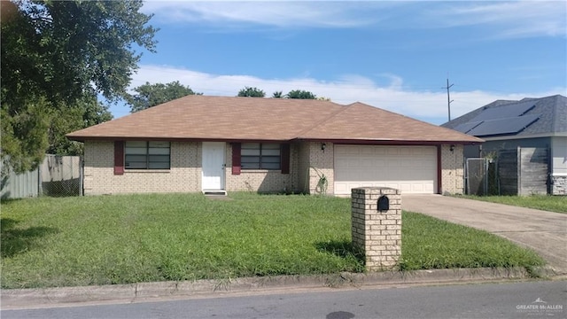 ranch-style house with a garage and a front lawn